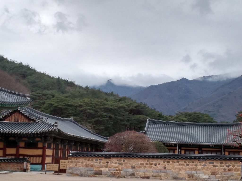 Buddha Treasure Temple view over rooftops to mountains and clouds